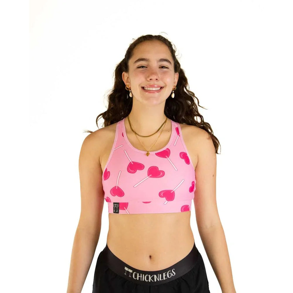 Young woman wearing pink sports bra with cherry lollipop pattern