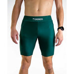 Man wearing ChicknLegs forest green 8-inch half tights against white background