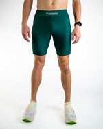 Man wearing ChicknLegs forest green athletic half tights shorts for running