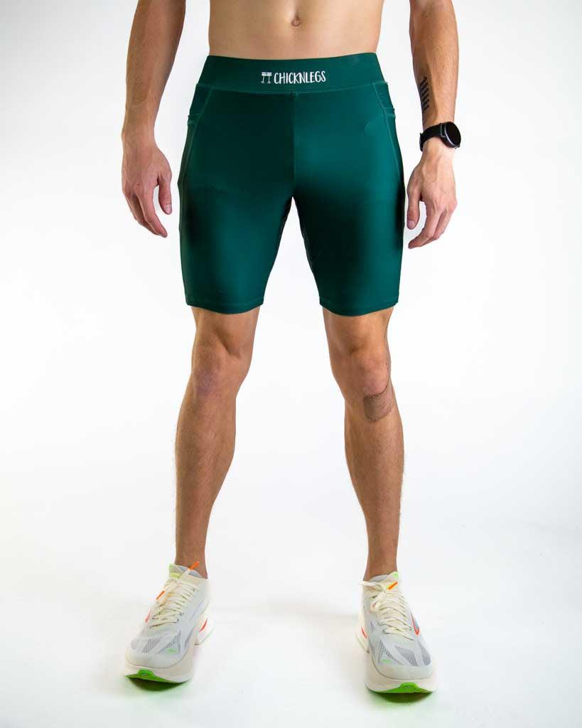 Man wearing ChicknLegs forest green athletic half tights shorts for running