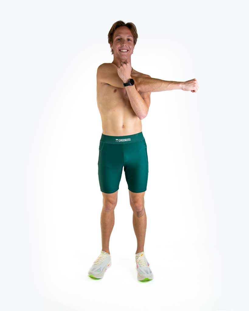 Man wearing ChicknLegs forest green 8-inch half tights in studio photo