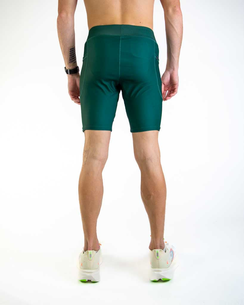 Back view of man wearing forest green athletic compression shorts