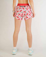 ChicknLegs 4-inch split running shorts in pink cherry print, rear view on model