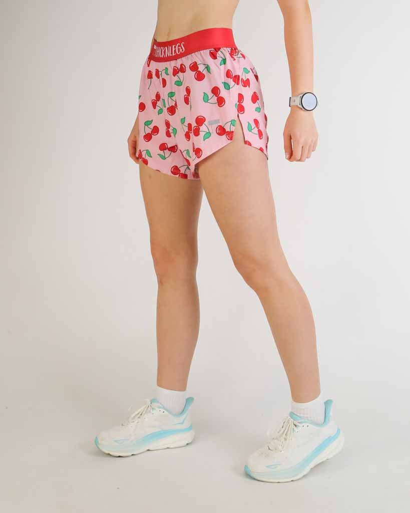 ChicknLegs 4-inch split running shorts in pink cherry print with red waistband