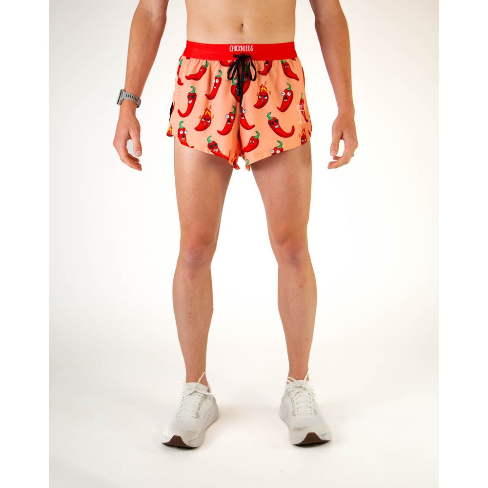 ChicknLegs men's running shorts with red chili pepper pattern on coral background
