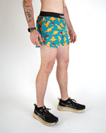 Man wearing blue dinosaur print running shorts with black waistband