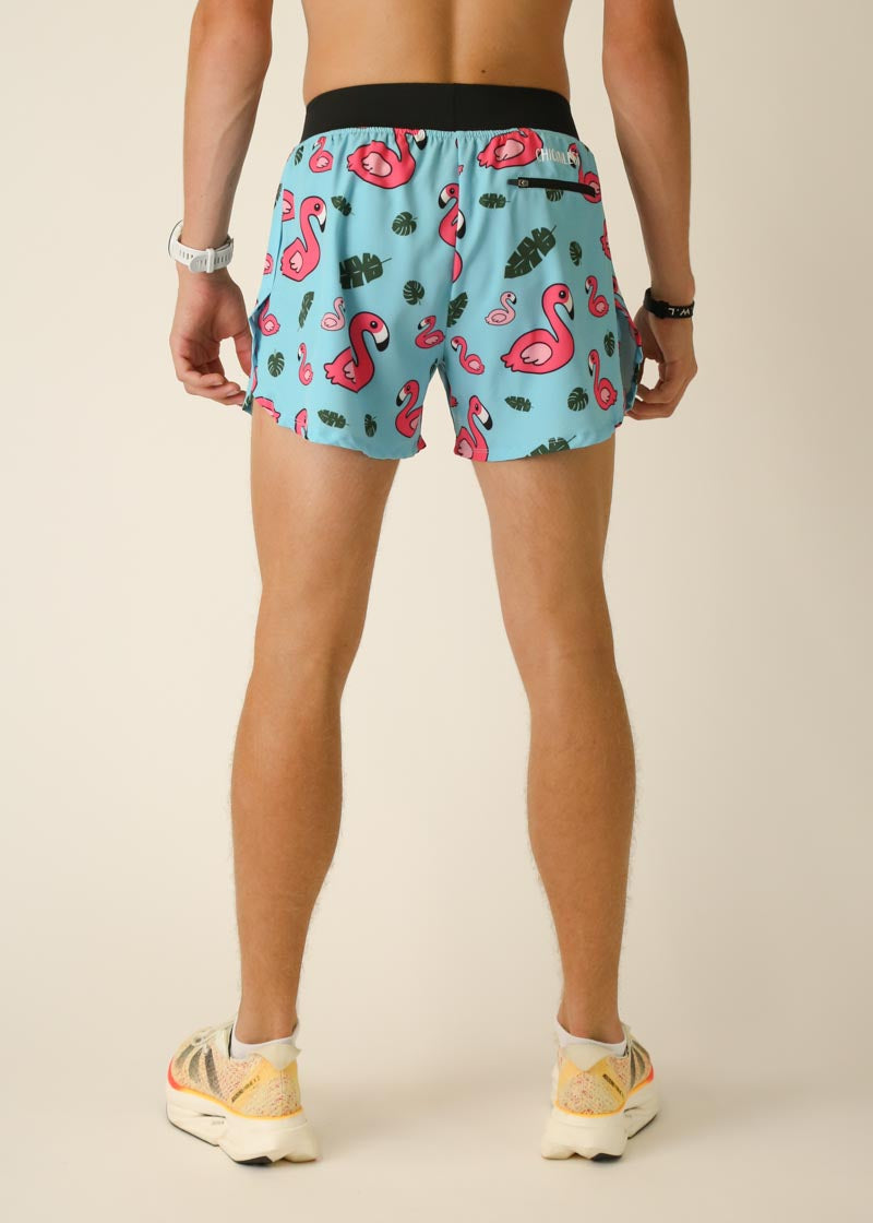 Men's light blue running shorts with pink flamingo pattern and split hem