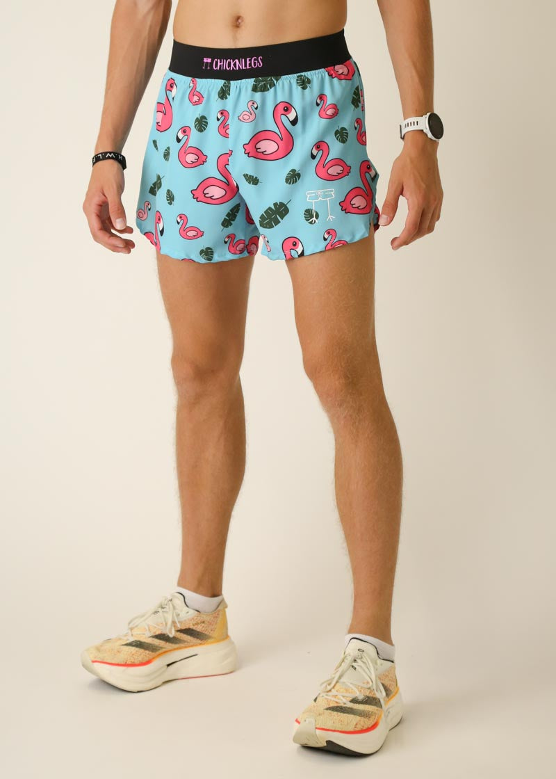 Man wearing light blue running shorts with pink flamingo pattern and black waistband