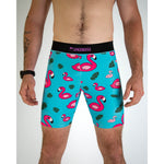 ChicknLegs men's blue flamingo patterned 8-inch compression shorts on male model
