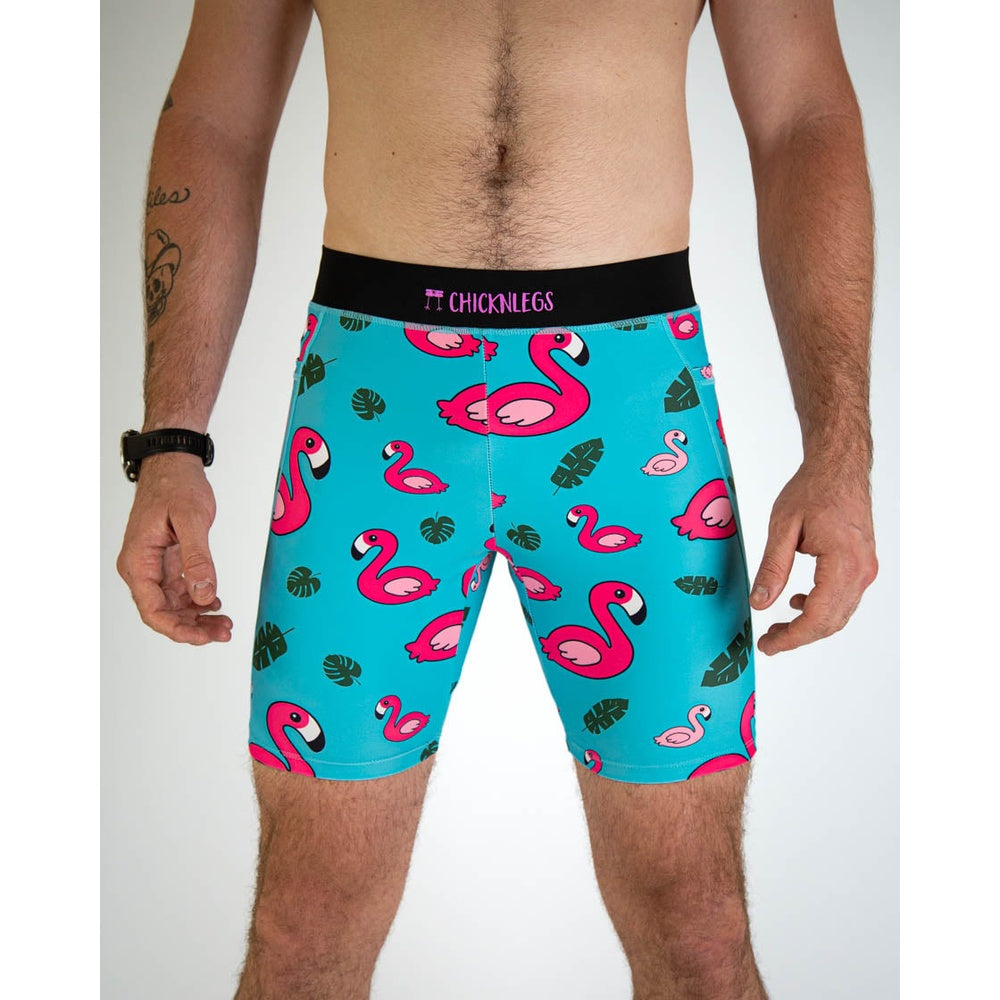ChicknLegs men's blue flamingo patterned 8-inch compression shorts on male model