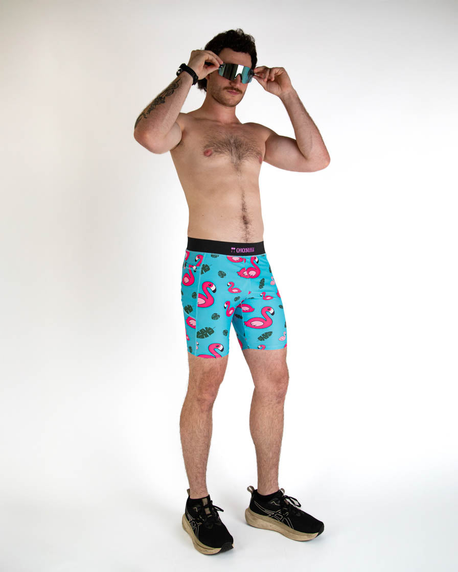 Man wearing ChicknLegs turquoise blue flamingo print compression shorts with sunglasses
