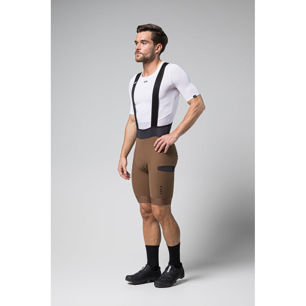 Man wearing Gobik Grit bib shorts in toffee brown color with white jersey