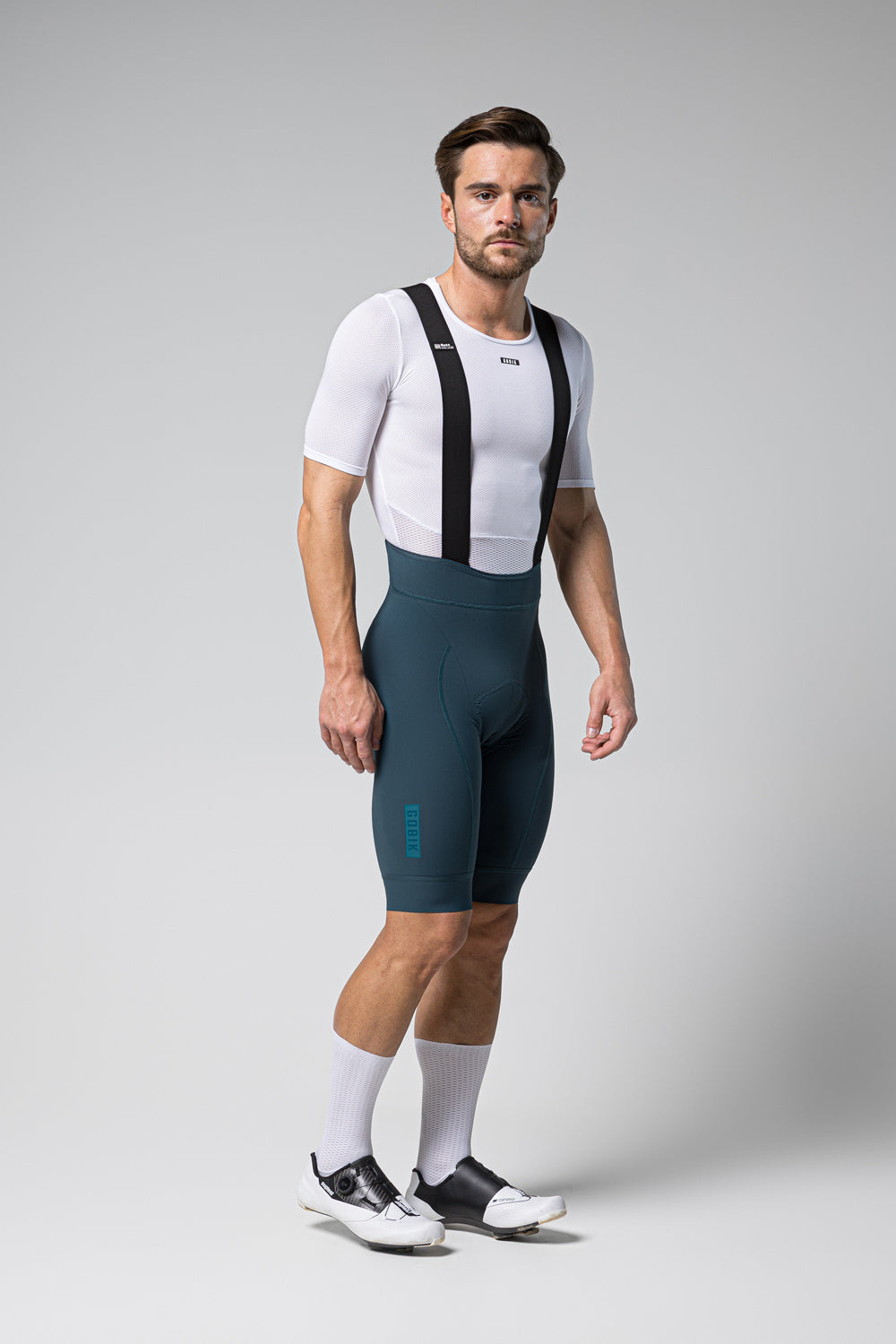 Male cyclist wearing Gobik Matt 2.0 bib shorts in corsair color with white base layer