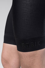 Gobik Absolute K9 black cycling bib shorts close-up showing leg gripper band