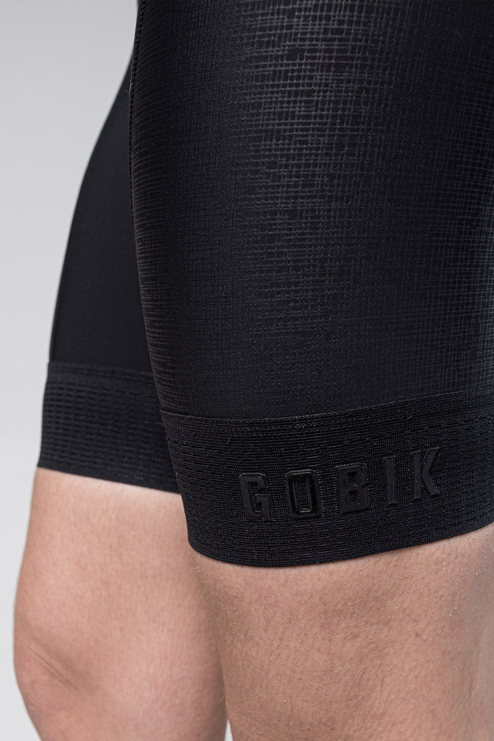 Gobik Absolute K9 black cycling bib shorts close-up showing leg gripper band