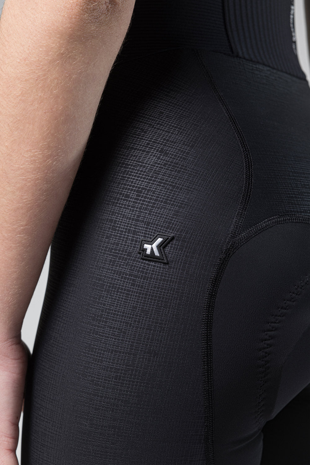 Gobik Absolute K9 women's black cycling bib shorts close-up showing textured fabric and logo