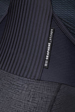 Close-up detail of Gobik Absolute K9 women's cycling culotte showing graphene straps label and multi-texture black fabric panels