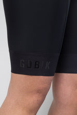Close-up of Gobik branded leg gripper band on black bib short lower hem