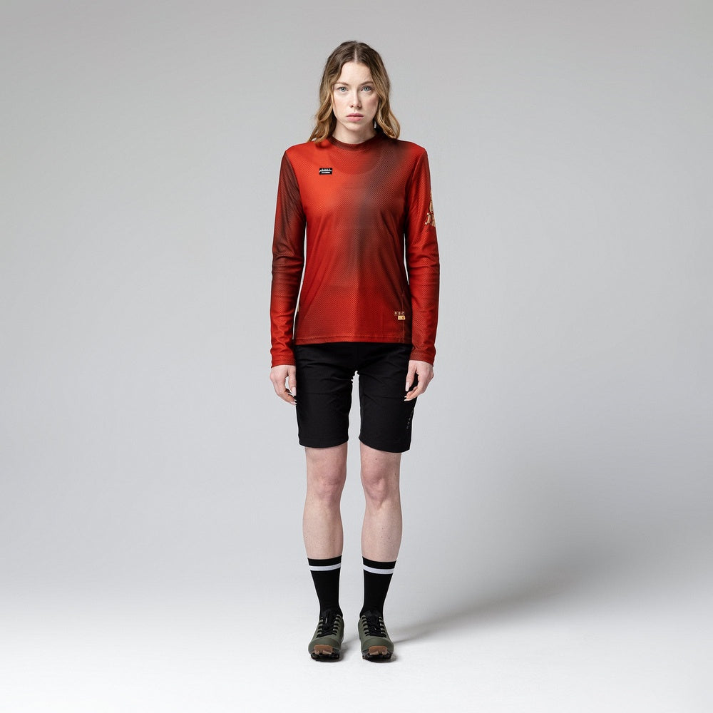Woman wearing red Gobik Terrain long sleeve cycling shirt with black shorts