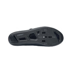 DMT cycling shoe sole showing black carbon fiber construction and cleat mounting holes