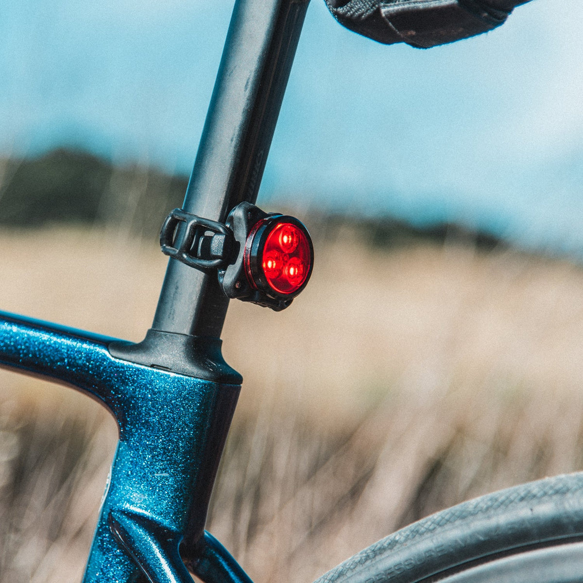 Lezyne Zecto Drive Alert rear bike light mounted on seatpost with red LEDs illuminated