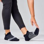 Feetures Elite Light Cushion Tab socks in black and grey worn during exercise