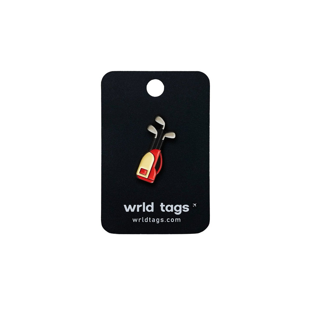 Wrld Tags enamel pin featuring a red and gold golf bag with silver clubs on black card