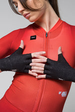 Black Gobik Mamba 2.0 fingerless cycling gloves worn by model in red jersey