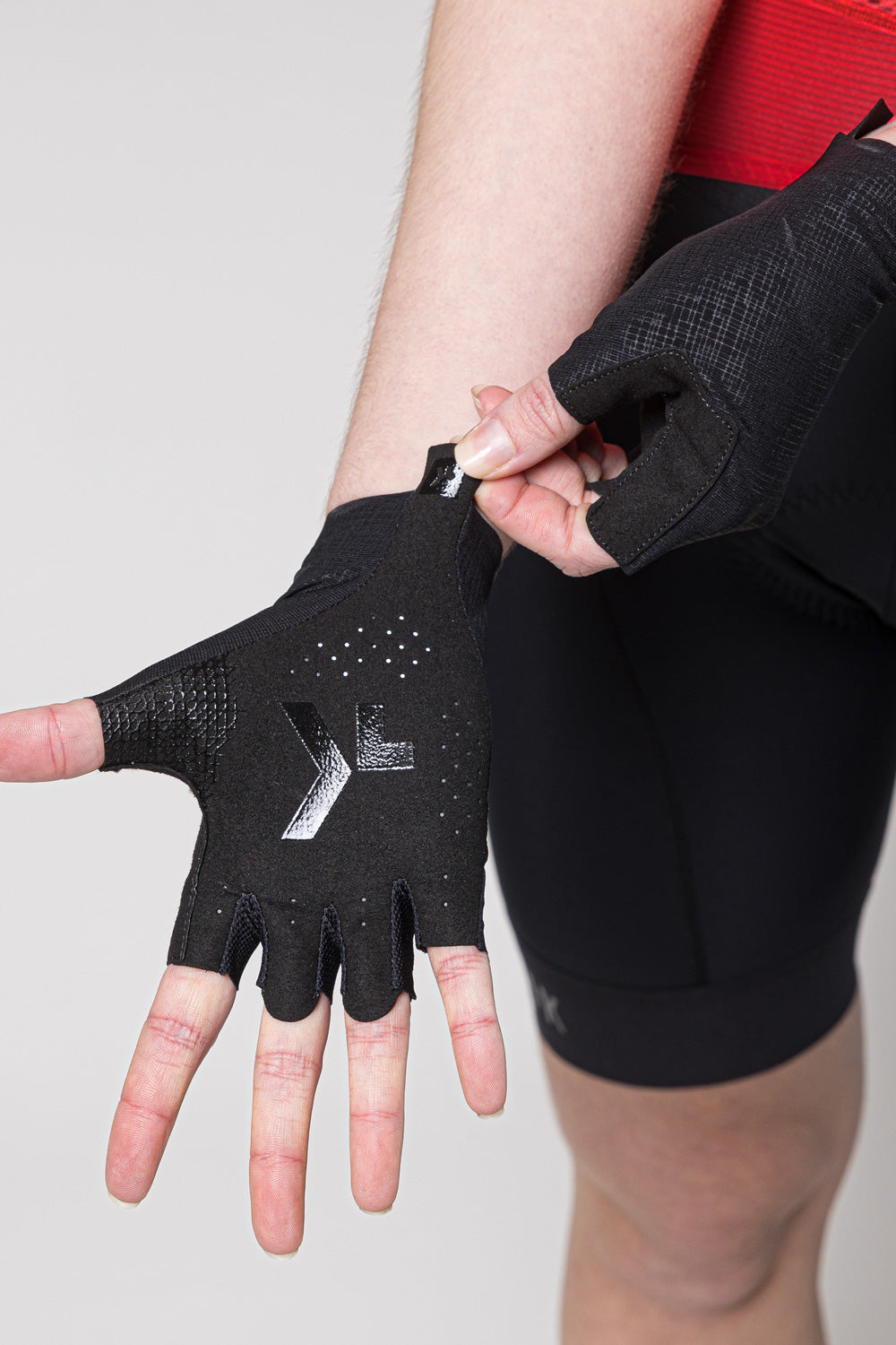 Black Gobik cycling gloves with fingerless design and perforated palm grip