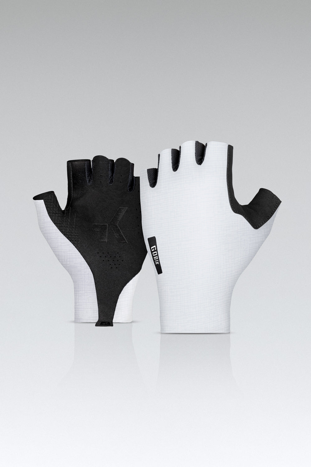 Gobik cycling gloves in white and black colorway with fingerless design