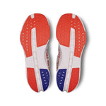 On Cloudsurfer Next Men's running shoe outsole view showing white, flame red, and blue rubber