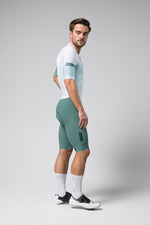 Male cyclist wearing Gobik Aero Brooklyn cycling suit in emerald green with white accents