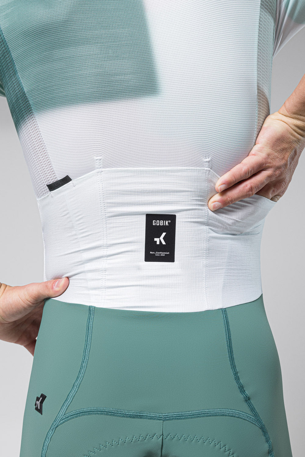 Gobik cycling suit in sage green and white showing back waistband detail