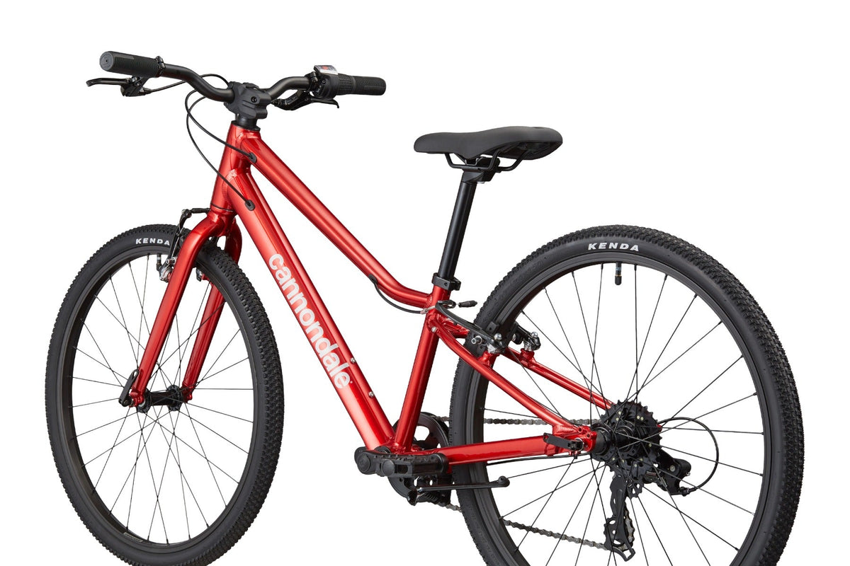 Close-up rear three-quarter view of Cannondale Kids Quick C2 in metallic red showing drivetrain and saddle