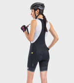 Woman wearing ALE Solid Blend bibshort in black with white mesh back panel