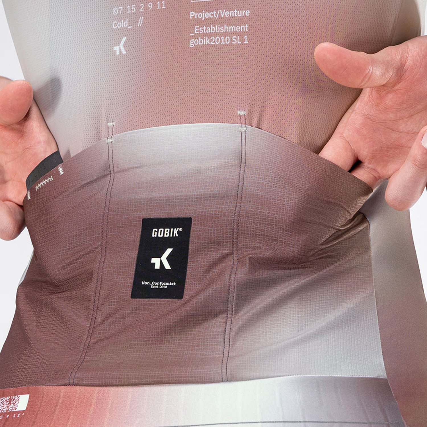 Close-up of Gobik Attitude 2.0 jersey back pockets being stretched open to show capacity