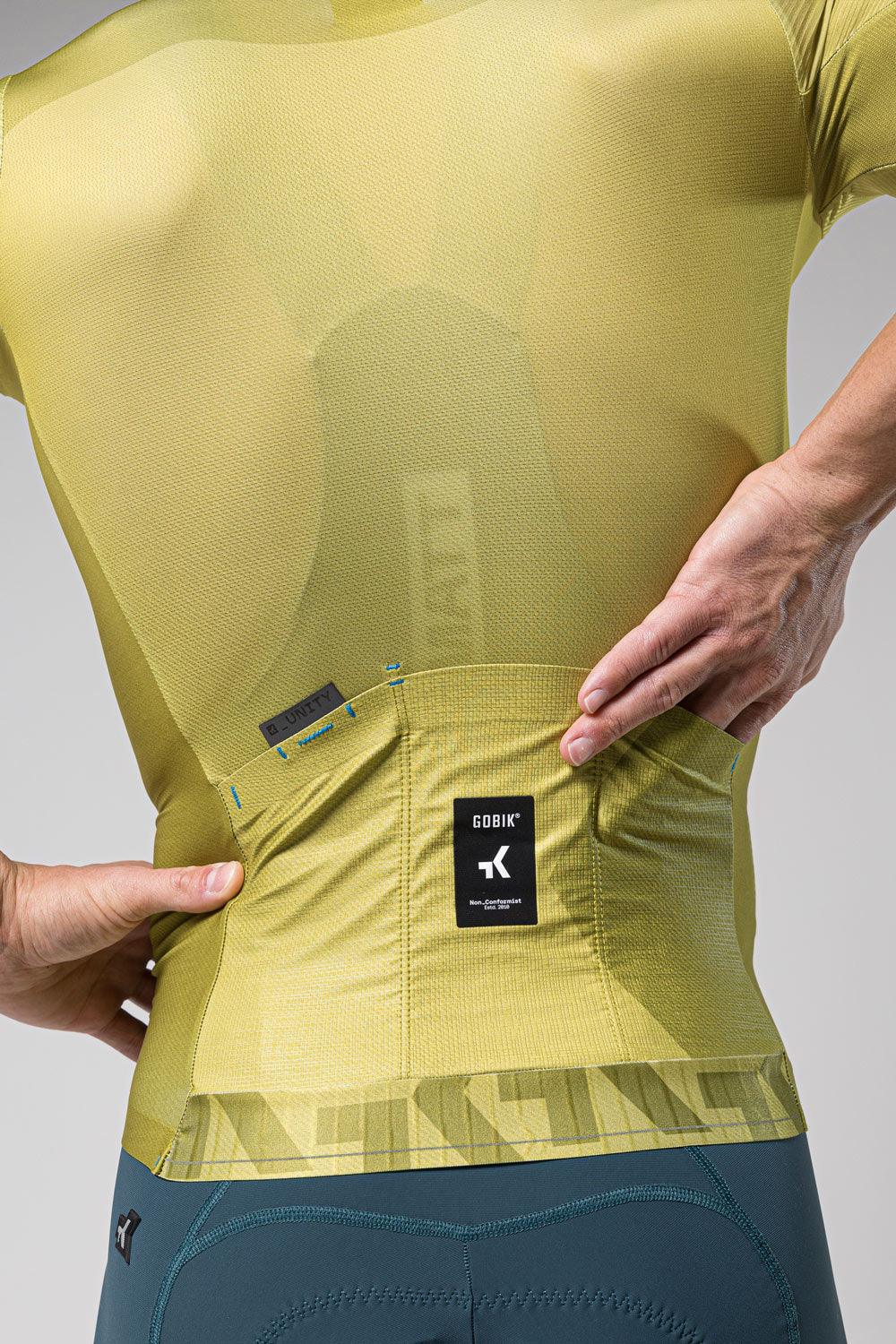 Gobik Attitude 2.0 cycling jersey in split green showing back pockets and logo
