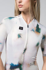Woman wearing GOBIK cycling jersey with abstract watercolor pattern in white background