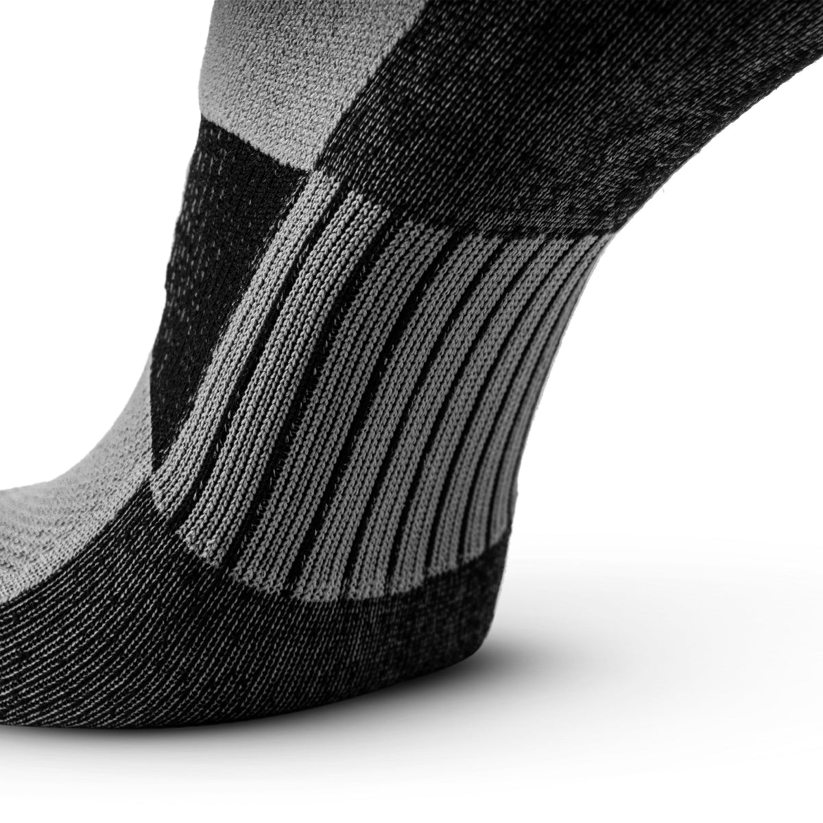 Close-up of black and grey no-show running sock showing arch support and heel construction