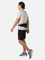 Man running wearing black Nathan Peak Hydration Waist Pack around waist