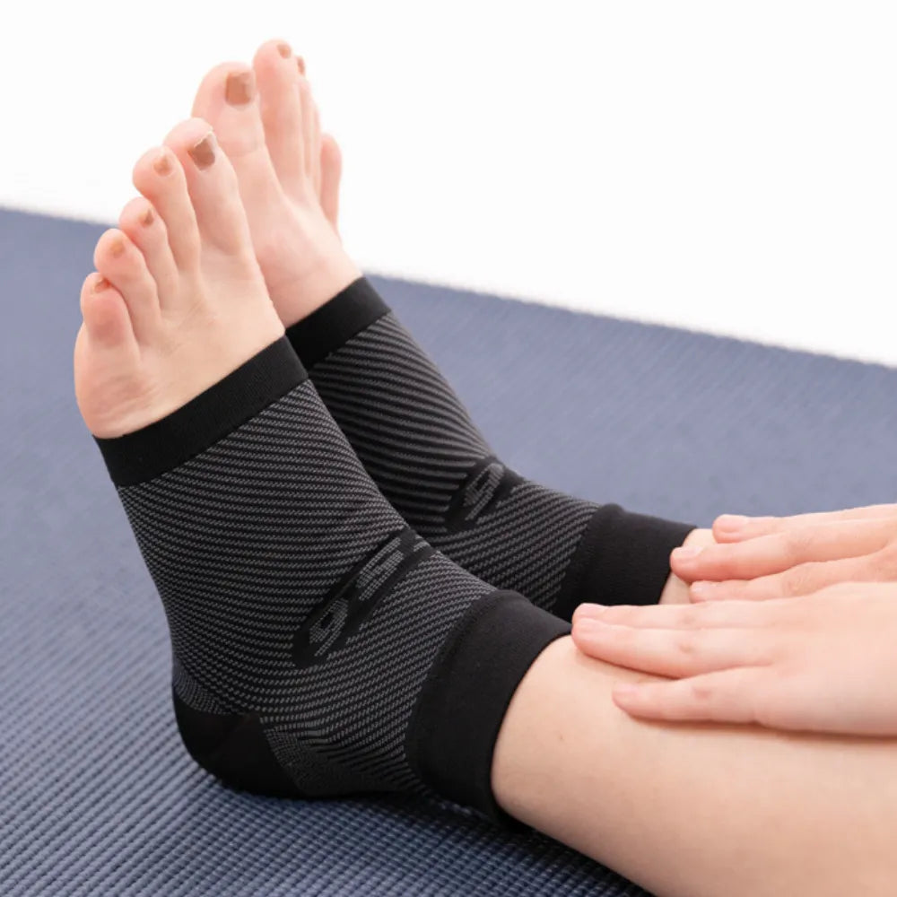OS1ST FS6 Performance Foot Sleeves in black worn on feet during exercise