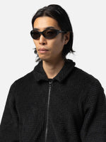 Male model wearing Oakley Eyejacket Redux sunglasses in matte black with PRIZM grey lenses