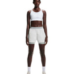 On Running Performance Bra in white paired with light green shorts, front view on model