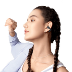 Woman wearing black Shokz OpenDots Air open-ear wireless earbuds with braided hair