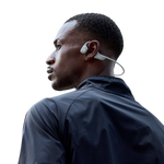 Man wearing white Shokz OpenRun Pro bone conduction headphones in profile view