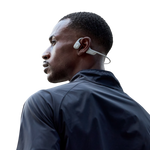 Man wearing light gray Shokz OpenRun Pro 2 bone conduction headphones during workout
