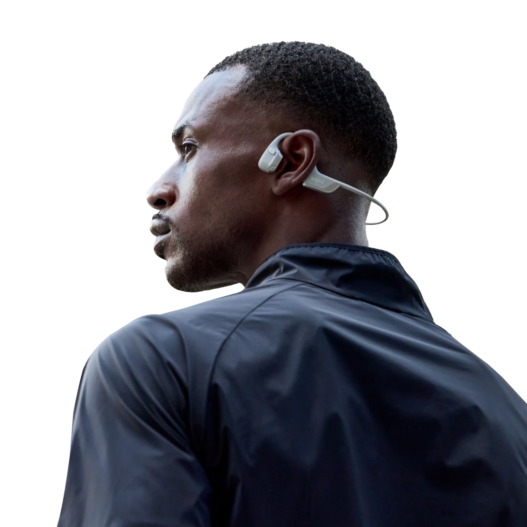Man wearing light gray Shokz OpenRun Pro 2 bone conduction headphones during workout