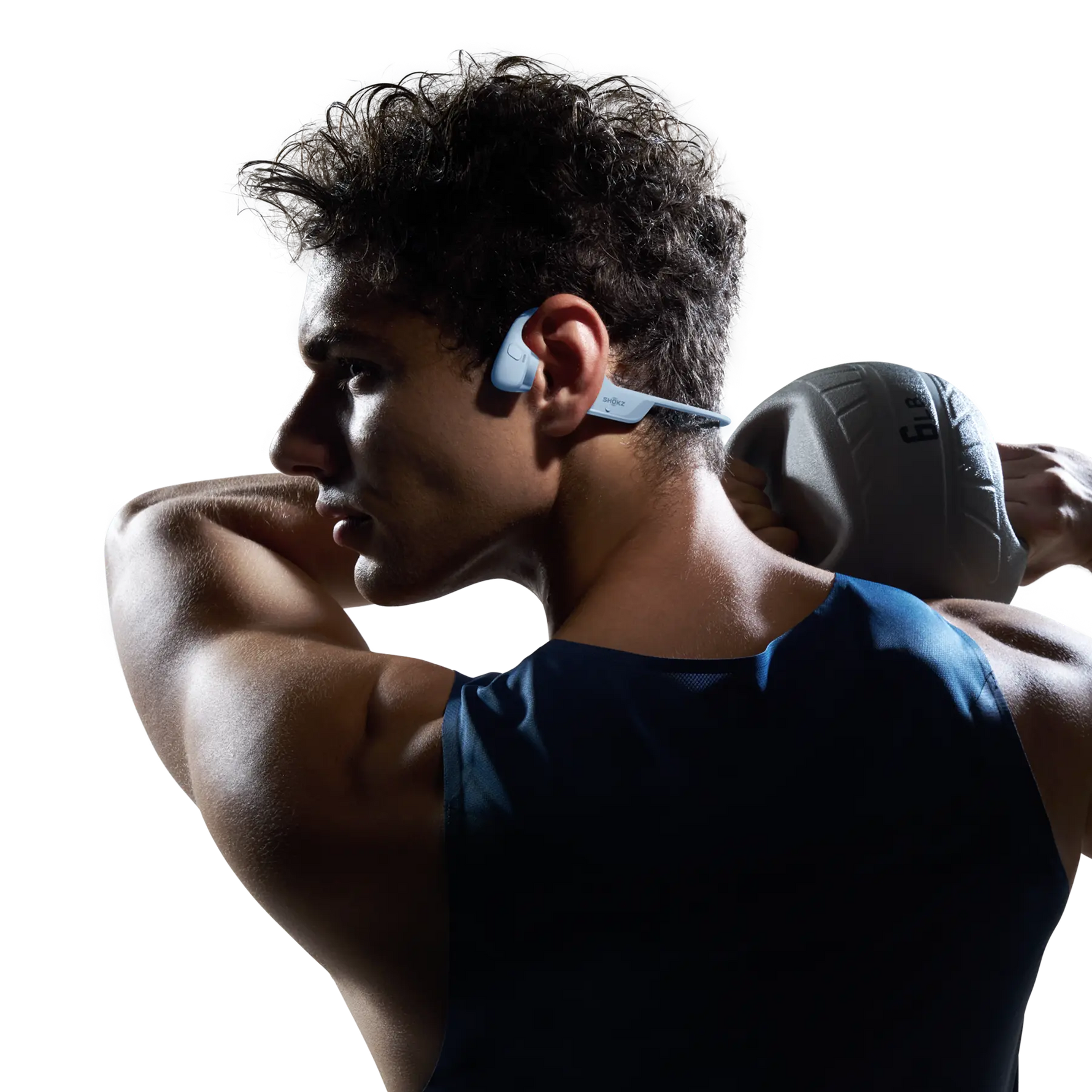 Athletic man wearing blue and white Shokz bone conduction headphones during workout