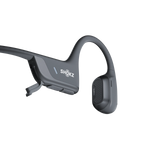 Gray Shokz bone conduction headphones with open-ear design and charging cable