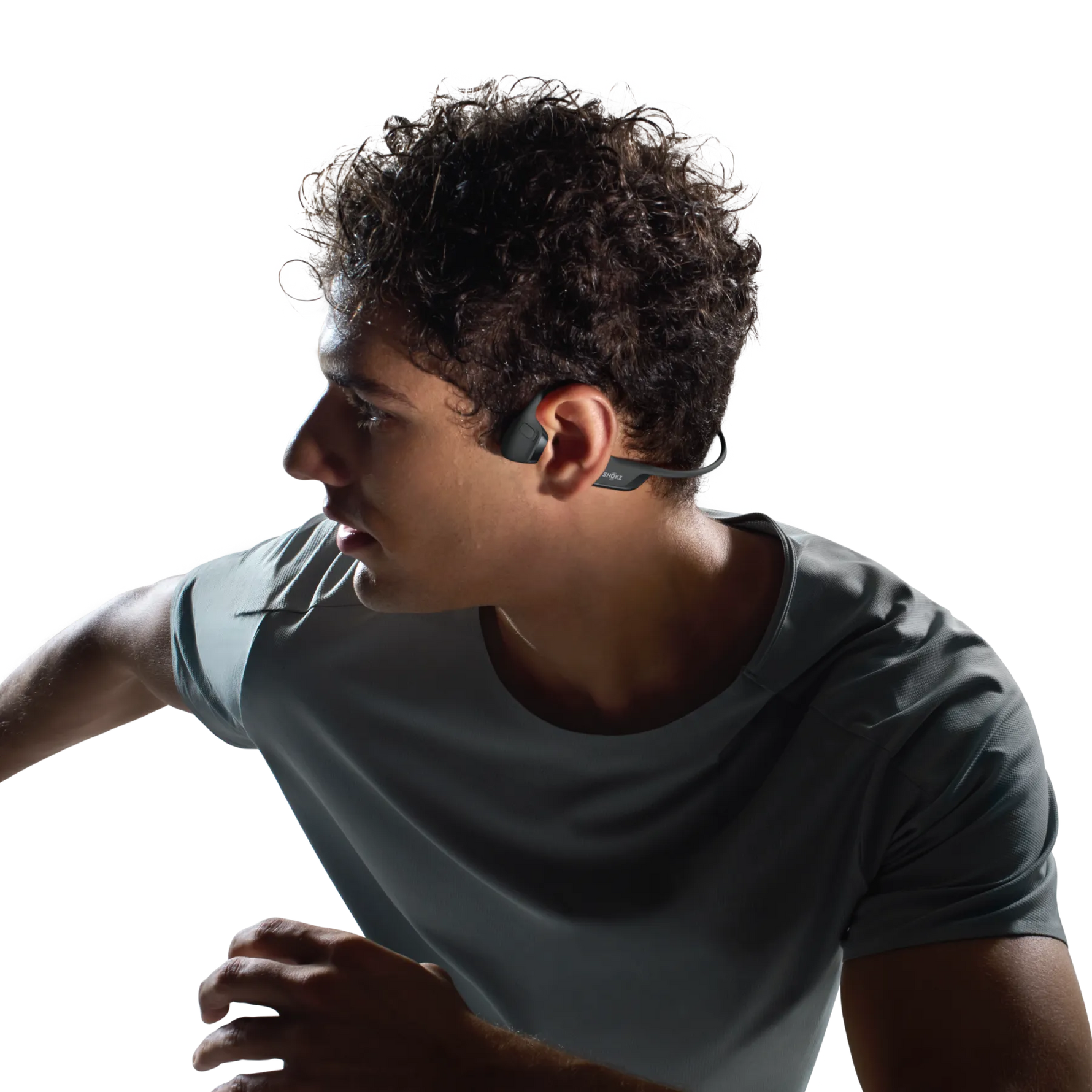 Man wearing black Shokz OpenRun Pro 2 bone conduction headphones while exercising